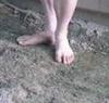 male feet on mud